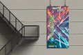 Personalized banner with colorful design and text hanging on a wall next to a staircase.
