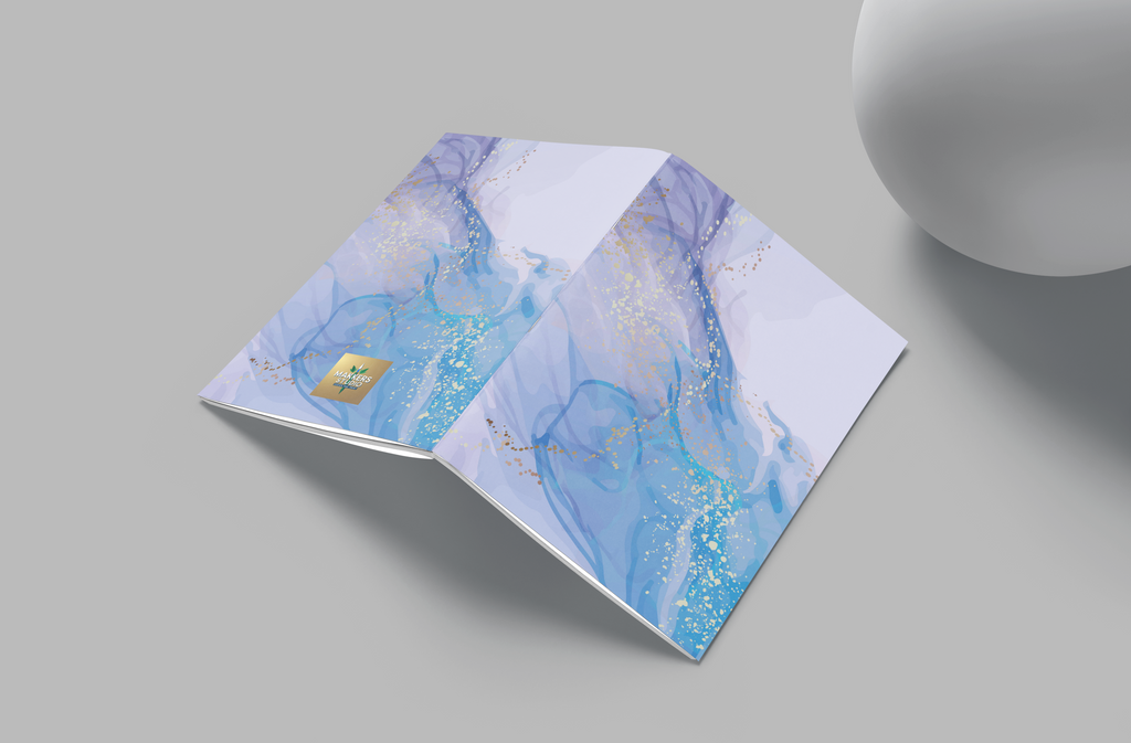 Folded paper with blue and white marbled design on a gray surface