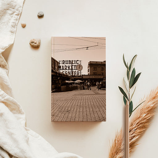 Sepia-toned Seattle fish market photography featuring a nostalgic marketplace scene with warm brown tones and vintage photographic styling.