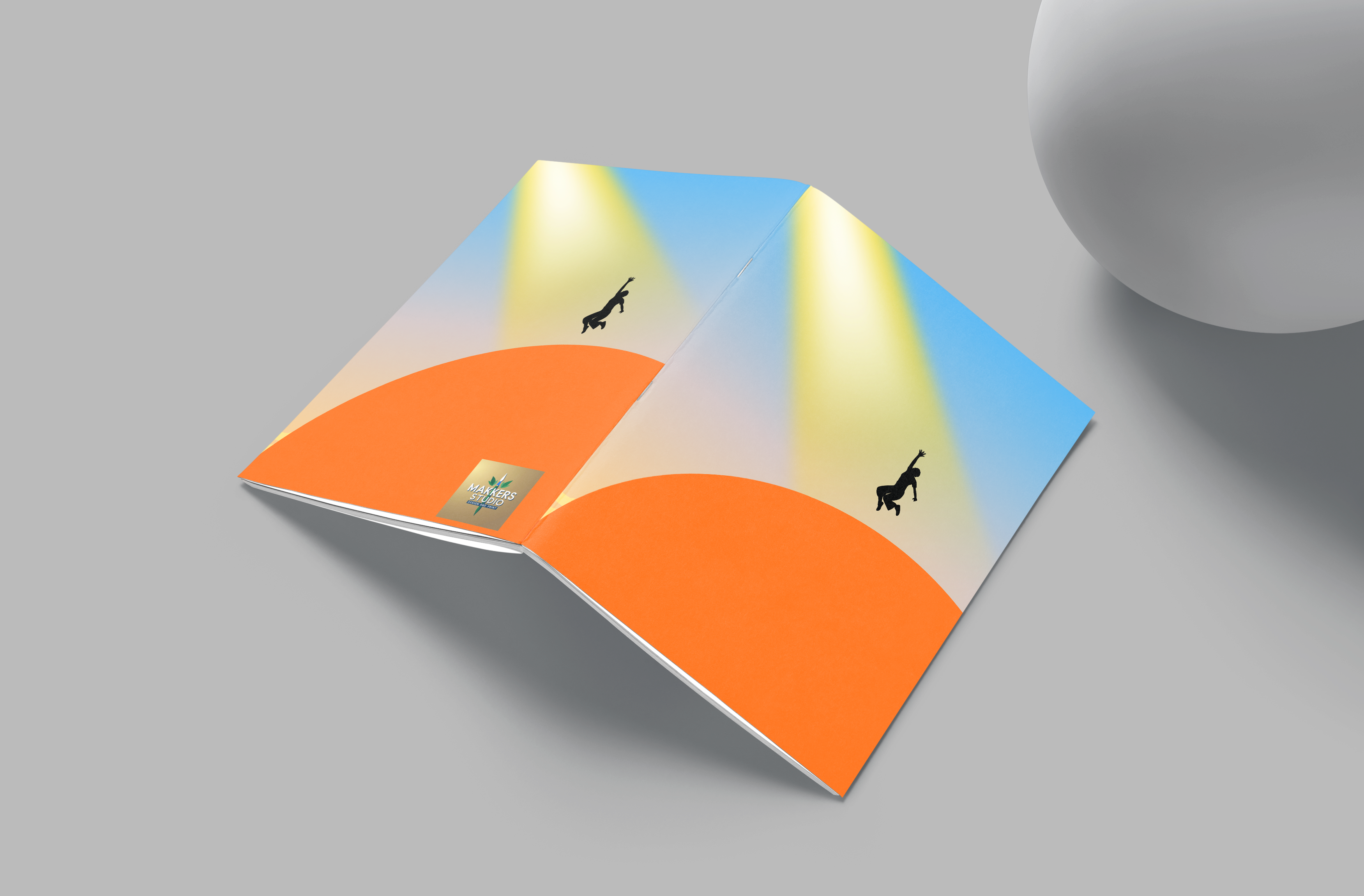 Colorful geometric design on a gray surface with a white object partially visible.