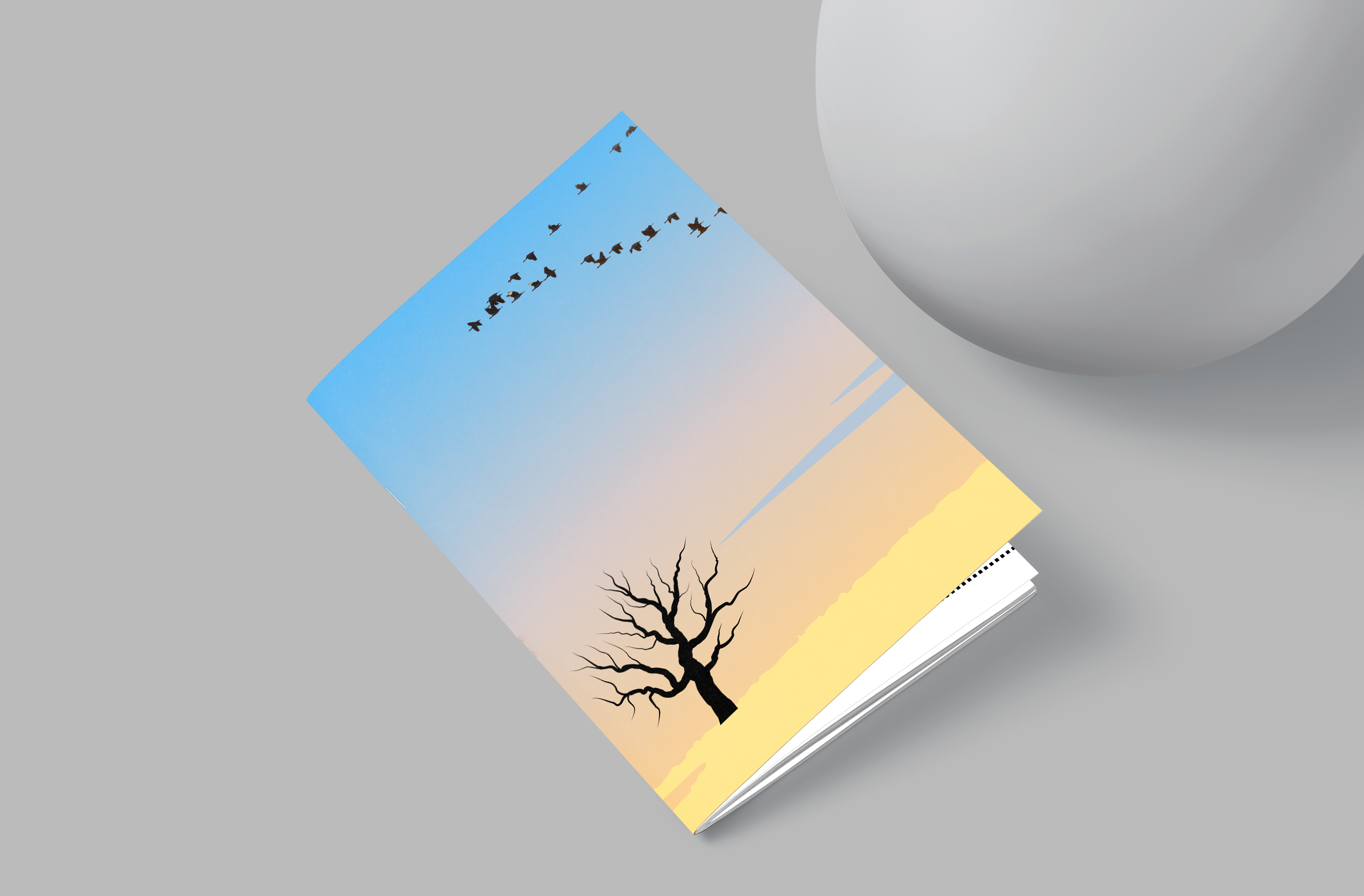 Book with a tree and bird design on a gray background