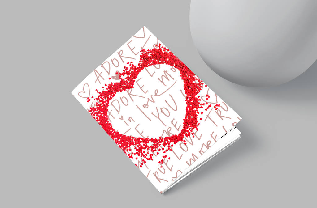 Notebook with red heart design and text on a gray background