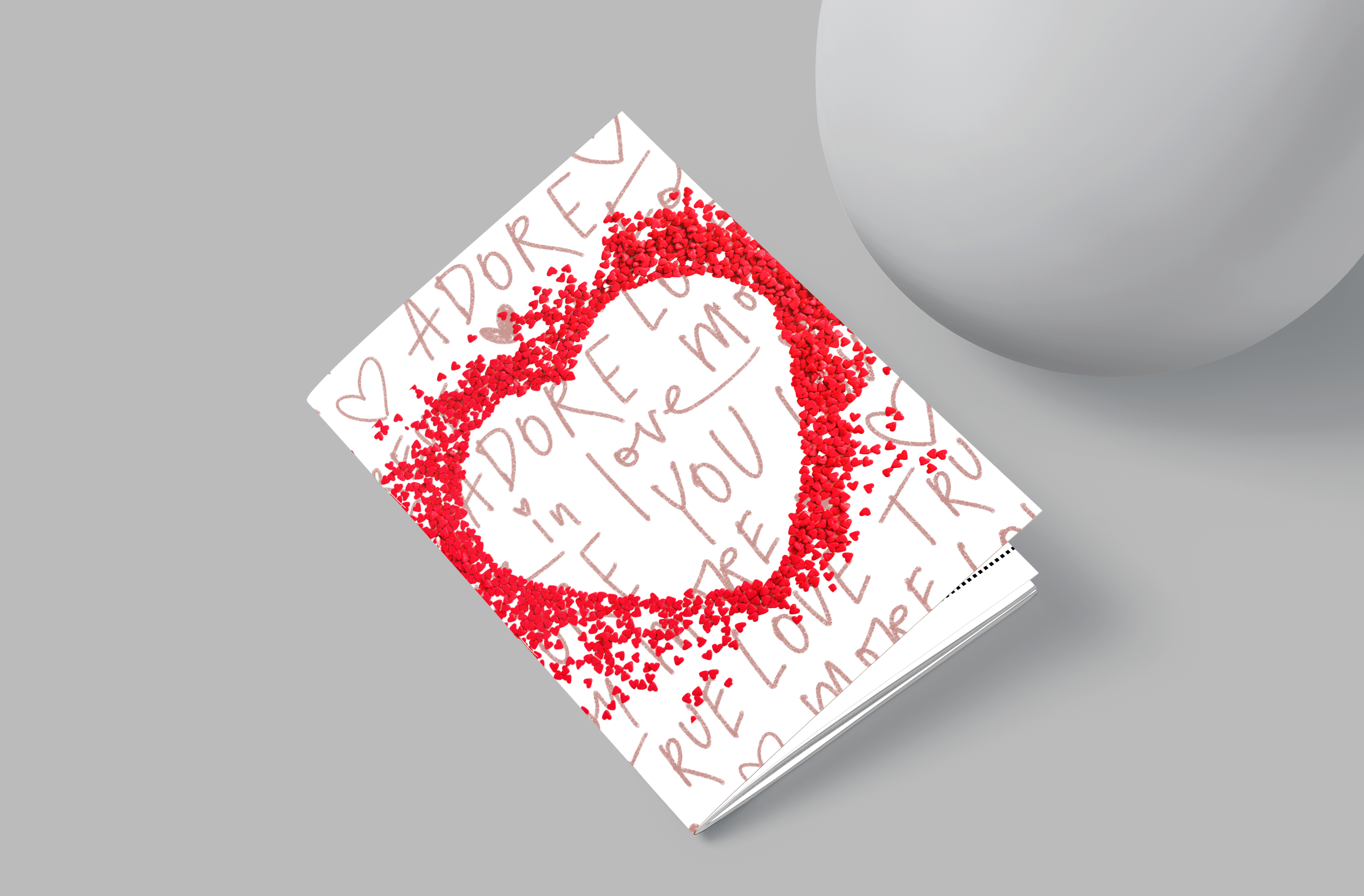 Notebook with red heart design and text on a gray background