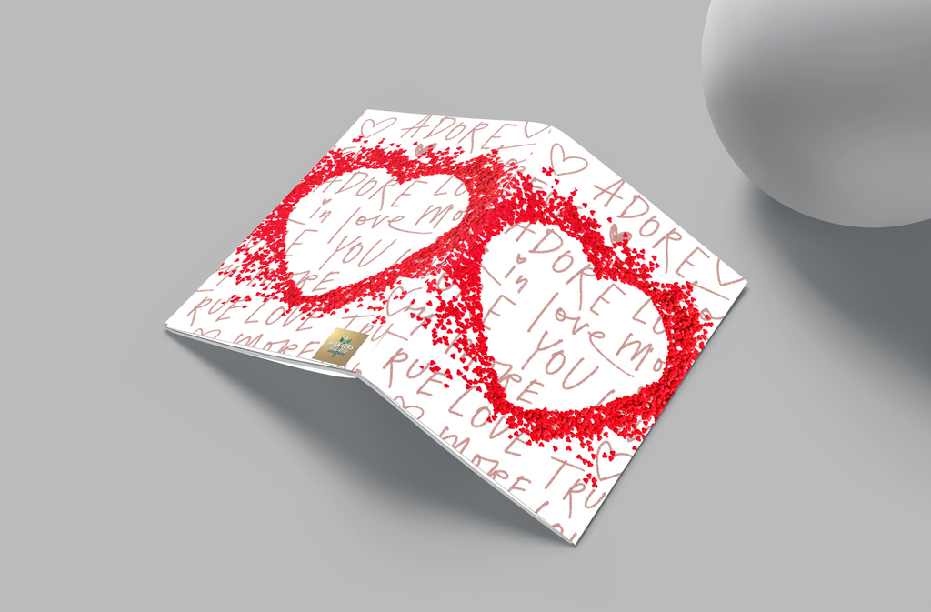 Card with red hearts and text on a gray surface