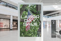Digital display in a store with 'Labor Day Sale' text and American flag.