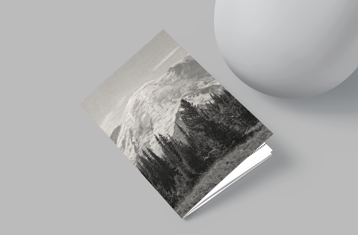Book with mountain landscape cover on a gray surface